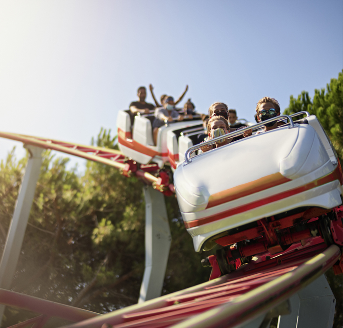 A group of people riding a roller coasted at Disney Land