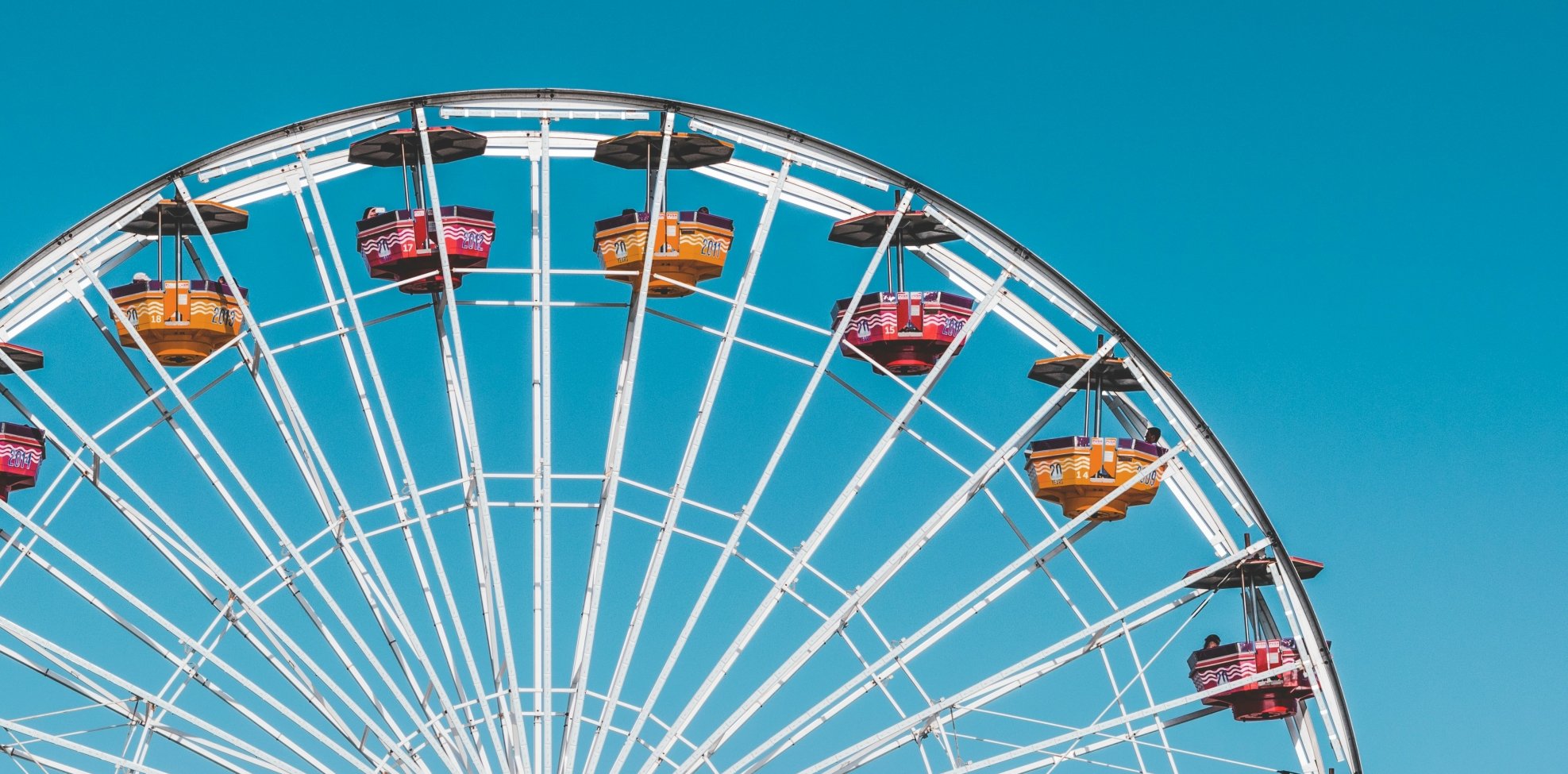 ferris wheel with colourful feats with blue sky