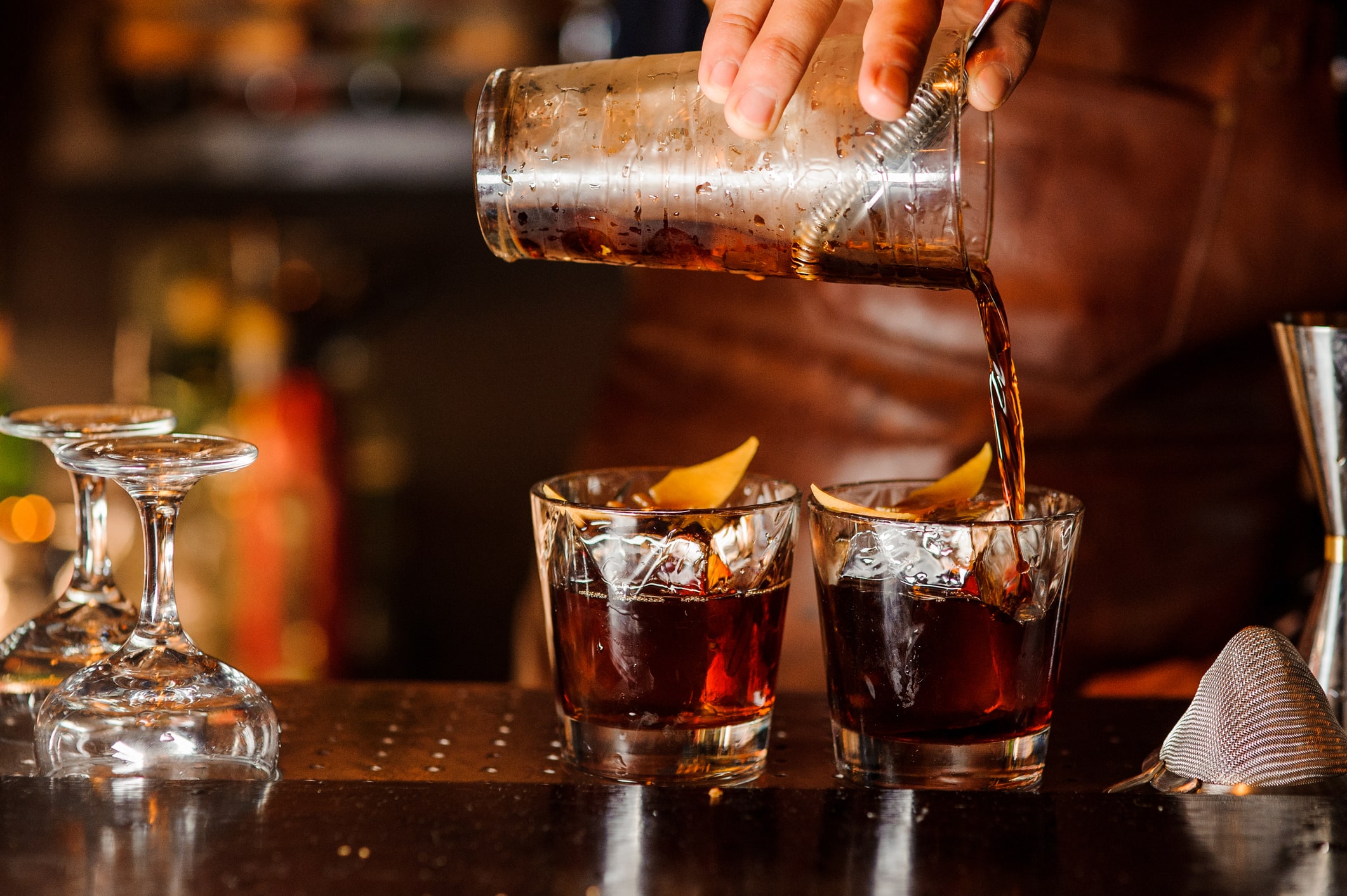 A bartender preparing drinks for customers at The Chestnut Club