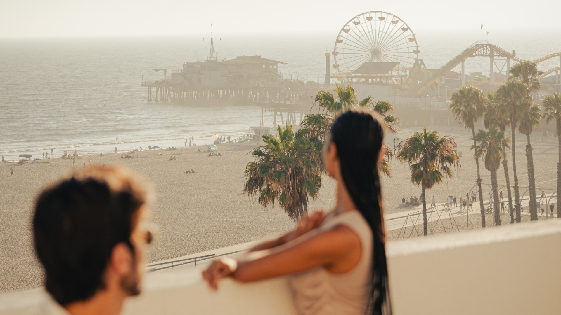 Couple enjoying balcony view of Santa Monica pier